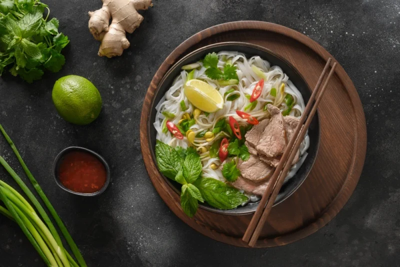 Pho bo soup with beef bowl black background Vietnamese cuisine